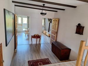 a living room with white walls and wooden floors at Powrócisz tu... in Sorkwity