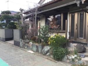 a house with a fence and flowers in front of it at Strawberry villa in Ichihara
