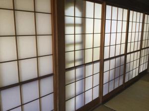 a pair of glass doors in a room at Strawberry villa in Ichihara
