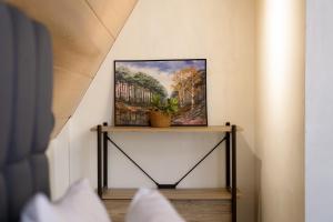 a painting on a table with a plant on it at Paraiso Del Bacnotan in Bacnotan