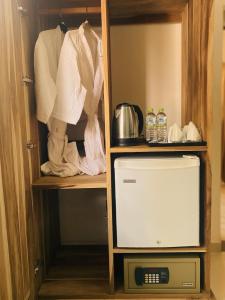 a closet with a microwave and a tv in it at H M C Leisure Villa Devinuwara in Dondra North +21 photos