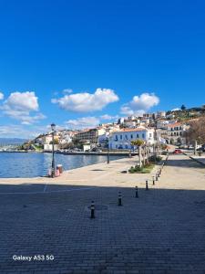 a cobblestone street next to a body of water at Three Charites Resort in Gialova