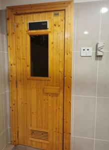 a wooden door with a window in a bathroom at Timurbay Seafront Kuantan Beach D'Sunset Ombak Samudera in Kuantan +12 photos