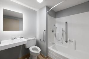 a bathroom with a sink and a toilet and a shower at Baymont by Wyndham Mankato in Mankato +22 photos
