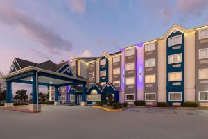 a rendering of a hotel with a parking lot at Microtel Inn and Suites Baton Rouge Airport in Baton Rouge