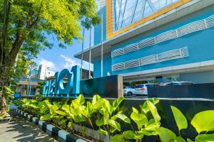 a building with a sign on the side of it at THE 1O1 Malang OJ in Malang