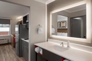 a bathroom with a sink and a mirror at Hawthorn Extended Stay by Wyndham Jackson in Jackson +19 photos