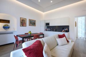 a living room with a white couch and a table at La casa di Mimí in Vico Equense