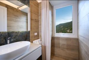 a bathroom with a sink and a window at La casa di Mimí in Vico Equense +39 photos