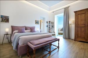 a bedroom with a large bed with purple pillows at La casa di Mimí in Vico Equense
