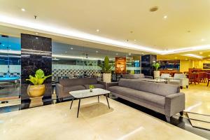 a living room with a couch and a table at THE 1O1 Malang OJ in Malang