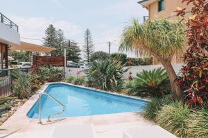 a swimming pool in the backyard of a house at Yamba Beach Motel in Yamba