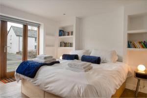 a bedroom with a large bed with towels on it at Croyde Barn in Croyde