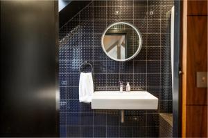 a bathroom with a sink and a mirror at Croyde Barn in Croyde +19 photos