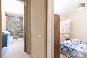 a small bedroom with a bed and a bathroom at Sea Breeze - Mare a 50mt & Terrazza Relax in Quartu SantʼElena