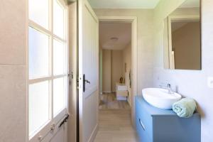 a bathroom with a sink and a mirror at Sea Breeze - Mare a 50mt & Terrazza Relax in Quartu SantʼElena +26 photos