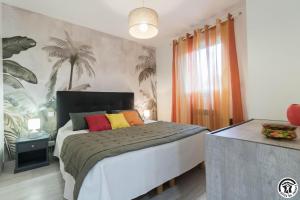 a bedroom with a large bed with colorful pillows at Villa les paradoux in Pin-Balma