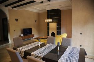 a dining room with a table and chairs at villa Marrakech 3chambre in Marrakesh