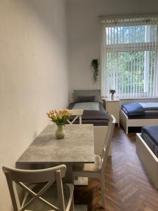 a living room with a table and chairs and a bed at Pension Nazli Elmshorn in Elmshorn +15 photos