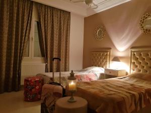 a bedroom with two beds and a candle on a table at Confort house in Nabeul
