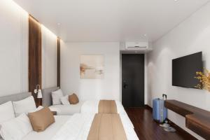 a hotel room with a bed and a flat screen tv at Thùy Dung 68 Hotel in Dong Hoi