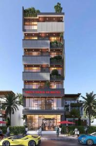 a rendering of a building with a yellow car in front at Thùy Dung 68 Hotel in Dong Hoi