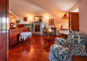 a living room with a fireplace and a chair at Mansarda Vista Mare Nel Verde in Quercianella