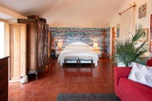 a bedroom with a bed in a room at Mansarda Vista Mare Nel Verde in Quercianella