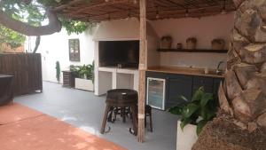 an outdoor kitchen with a counter and a stool at Apartamento turístico in Orihuela Costa