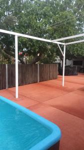 a pergola over a swimming pool on a patio at Apartamento turístico in Orihuela Costa