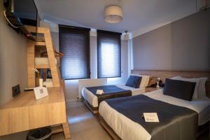 a room with two beds and a bunk bed at Utkubey Hotel in Gaziantep