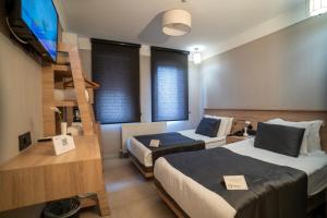 a hotel room with two beds and a staircase at Utkubey Hotel in Gaziantep