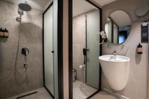a bathroom with a sink and a shower with a mirror at Utkubey Hotel in Gaziantep +13 photos