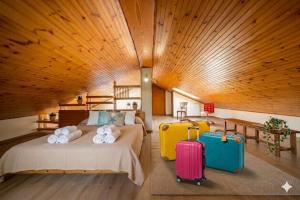 a bedroom with two beds and two suitcases at Casa Liselotte in Imperia