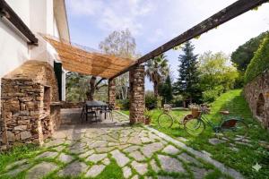 a patio with a hammock and a table and two bikes at Casa Liselotte in Imperia