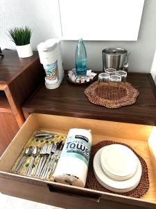 a drawer with plates and utensils in a kitchen at Kauai Beach Resort in Lihue
