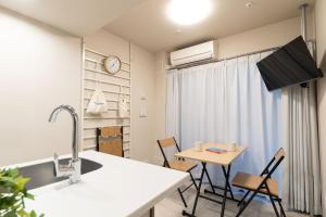 a kitchen and dining room with a table and chairs at BON Tokyo Kamata Parkside in Tokyo