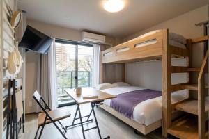a bedroom with a bunk bed and a desk at BON Tokyo Kamata Parkside in Tokyo