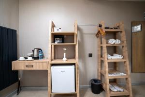 a room with a bunk bed and a desk and shelves at Utkubey Hotel in Gaziantep