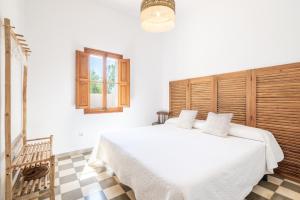 a bedroom with a large white bed with a window at Palma Ca'n Alonso in Palma de Mallorca +19 photos