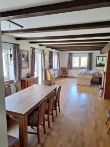 a large living room with a wooden table and chairs at Powrócisz tu... in Sorkwity