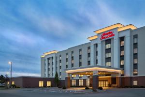 a hotel building with a sign on top of it at Hampton Inn & Suites Syracuse North Airport Area in North Syracuse