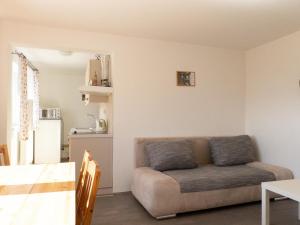 a living room with a couch and a table at Apartmán Dvojka in Benecko