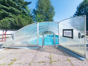 a large glass greenhouse with a pool inside at Apartmán Dvojka in Benecko