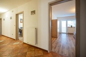 an empty room with a door open to a living room at Apartment Molnar in Žirovnica +25 photos