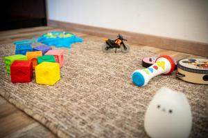 a group of toys sitting on a rug at Apartment Molnar in Žirovnica