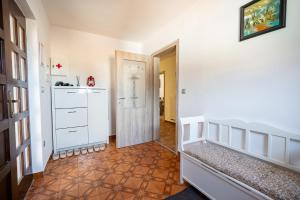 a room with a bedroom with a crib and a door at Apartment Molnar in Žirovnica