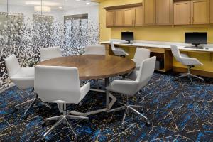 a conference room with a wooden table and white chairs at Hampton Inn & Suites Syracuse North Airport Area in North Syracuse +35 photos