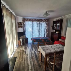 a living room with a table and a couch at Casa Nel Verde Vista Mare in Quercianella
