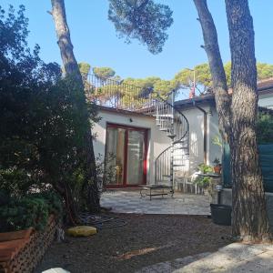 a house with a staircase and a patio at Casa Nel Verde Vista Mare in Quercianella